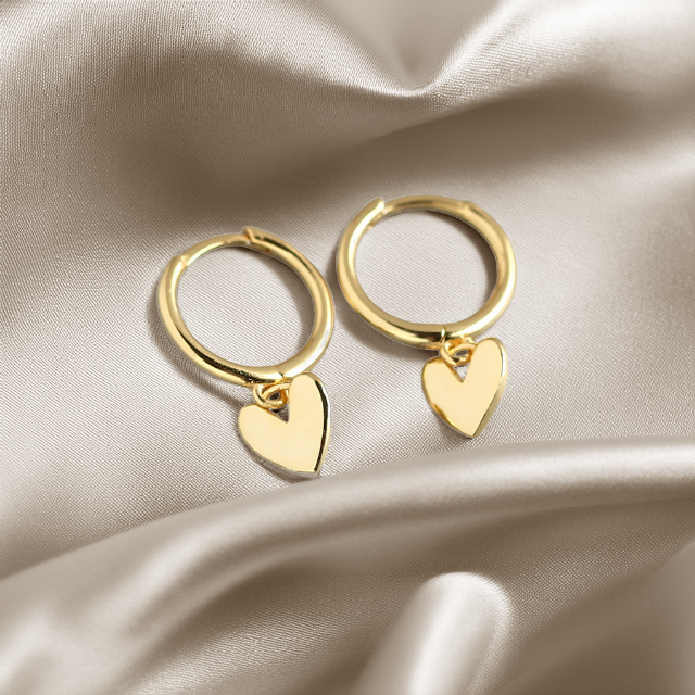 Heart charm huggie earring in gold